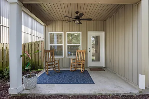 a view of a backyard with wooden fence