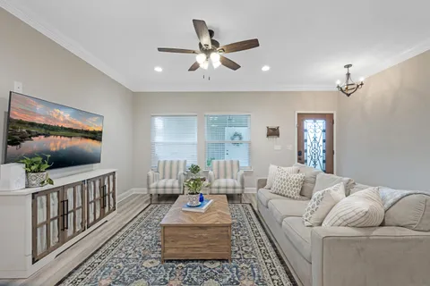 a living room with furniture and a flat screen tv