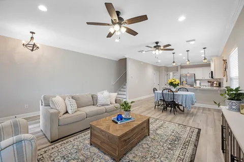 a living room with furniture and kitchen view