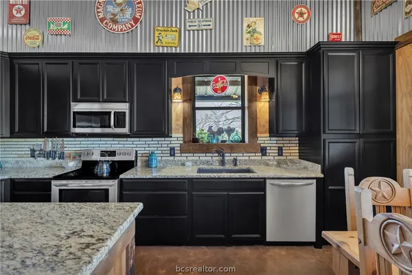 a bedroom with a bed and large windows