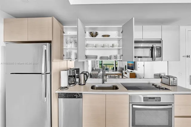 a kitchen with a refrigerator a stove and a cabinets