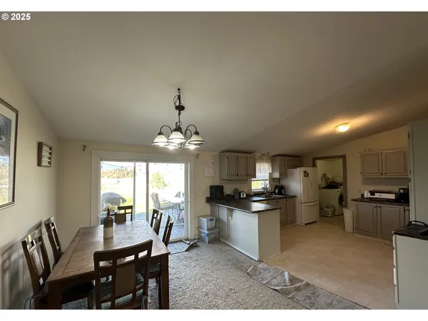a kitchen with refrigerator and cabinets