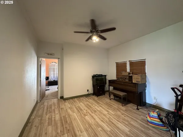 a view of a livingroom with wooden floor and furniture