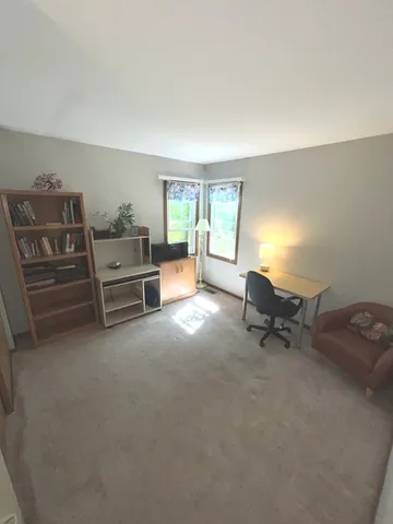 a view of a livingroom with furniture and windows