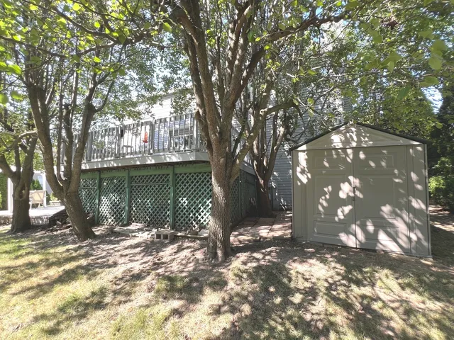 a backyard of a house with lots of green space and fountain