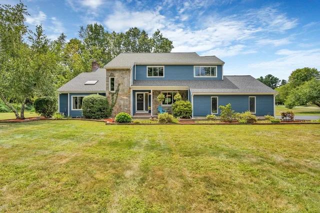 a front view of a house with swimming pool having outdoor seating