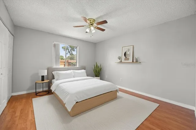 a bedroom with a large bed and a chandelier