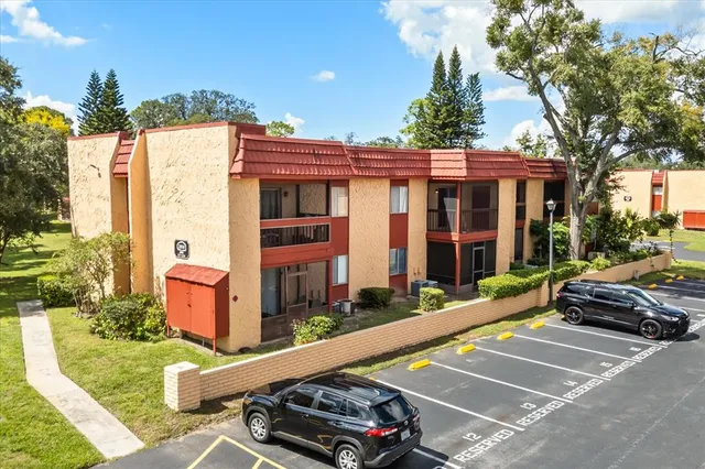 a car parked in front of a house with a yard