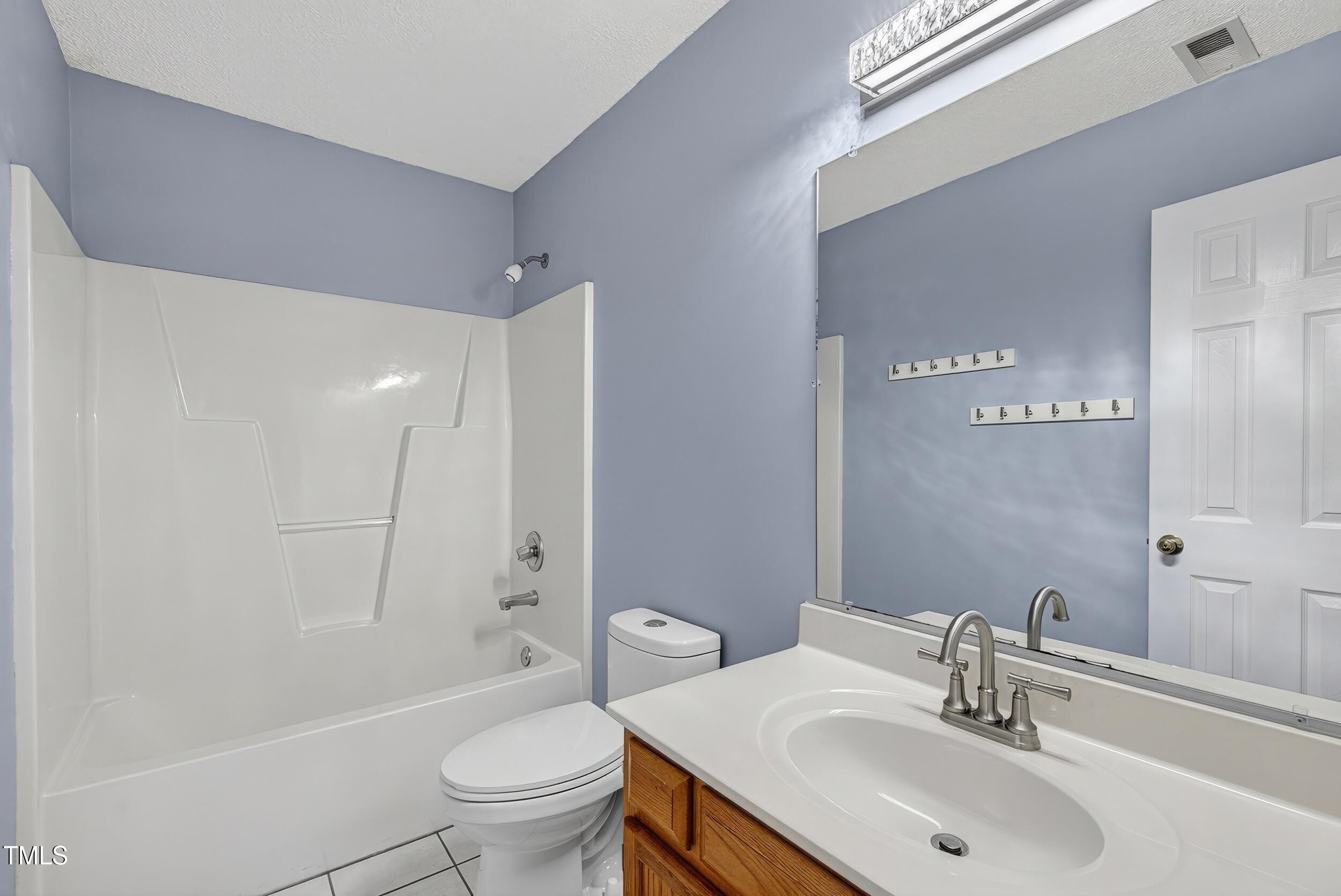 532 Baygall Road Holly Springs, NC 27540 - Photo 13 of 15 a bathroom with a sink a toilet and shower