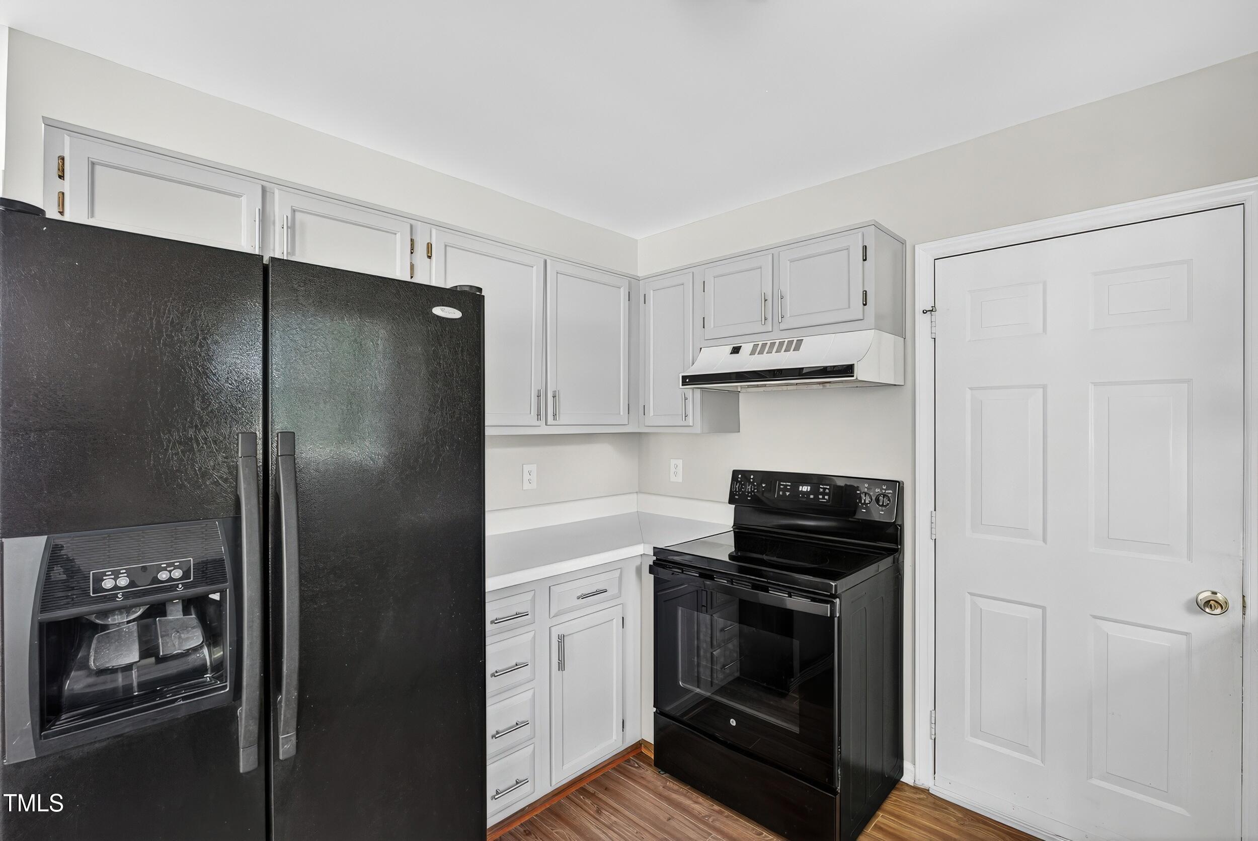 532 Baygall Road Holly Springs, NC 27540 - Photo 5 of 15 a kitchen with a refrigerator and a stove top oven
