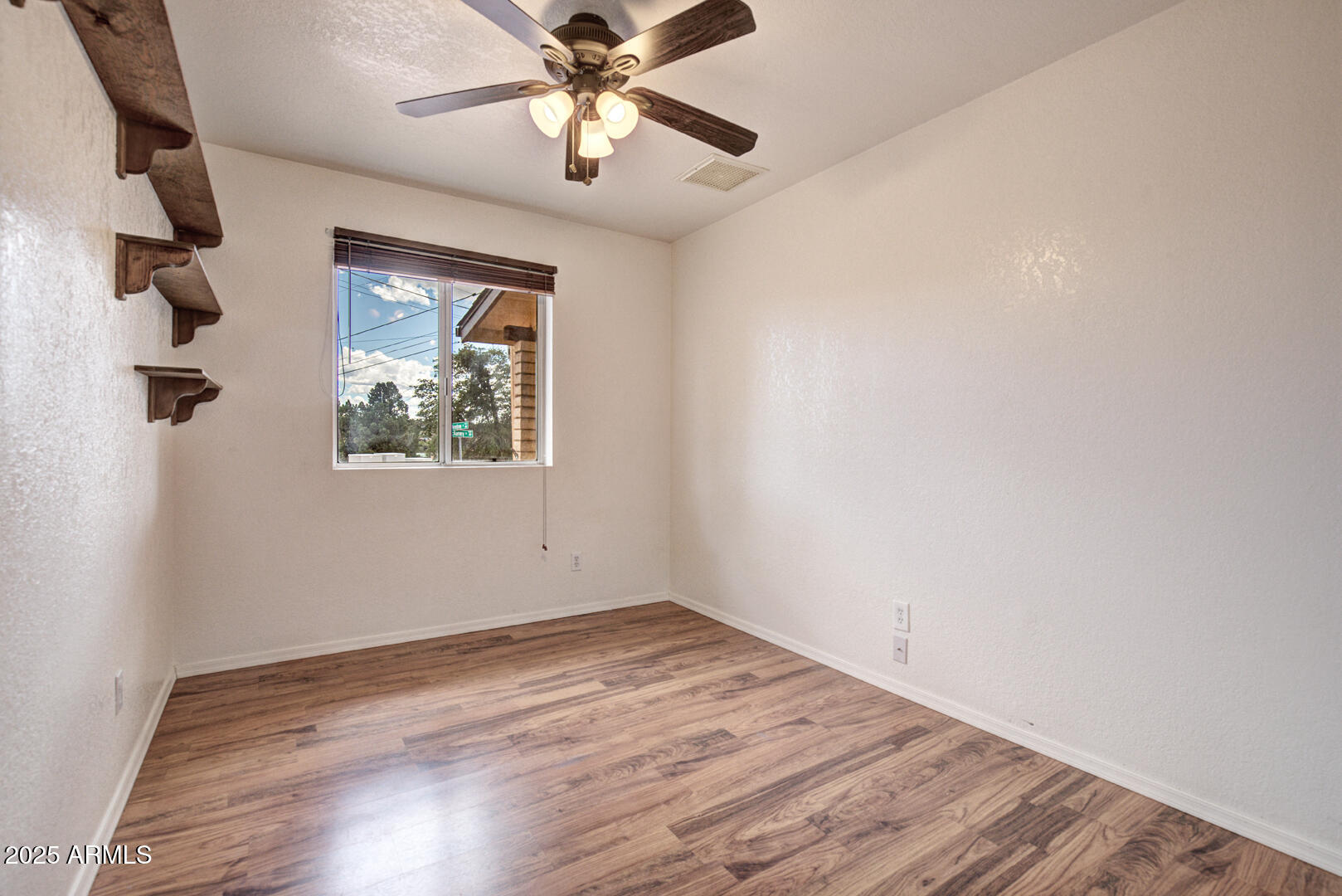 508 South Meadow Street Payson, AZ 85541 - Photo 14 of 29 an empty room with wooden floor fan and windows