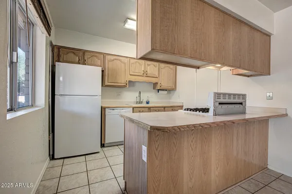 a kitchen with stainless steel appliances granite countertop a refrigerator sink and cabinets