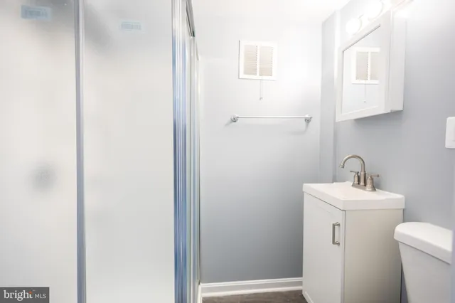 a bathroom with a sink a toilet and vanity