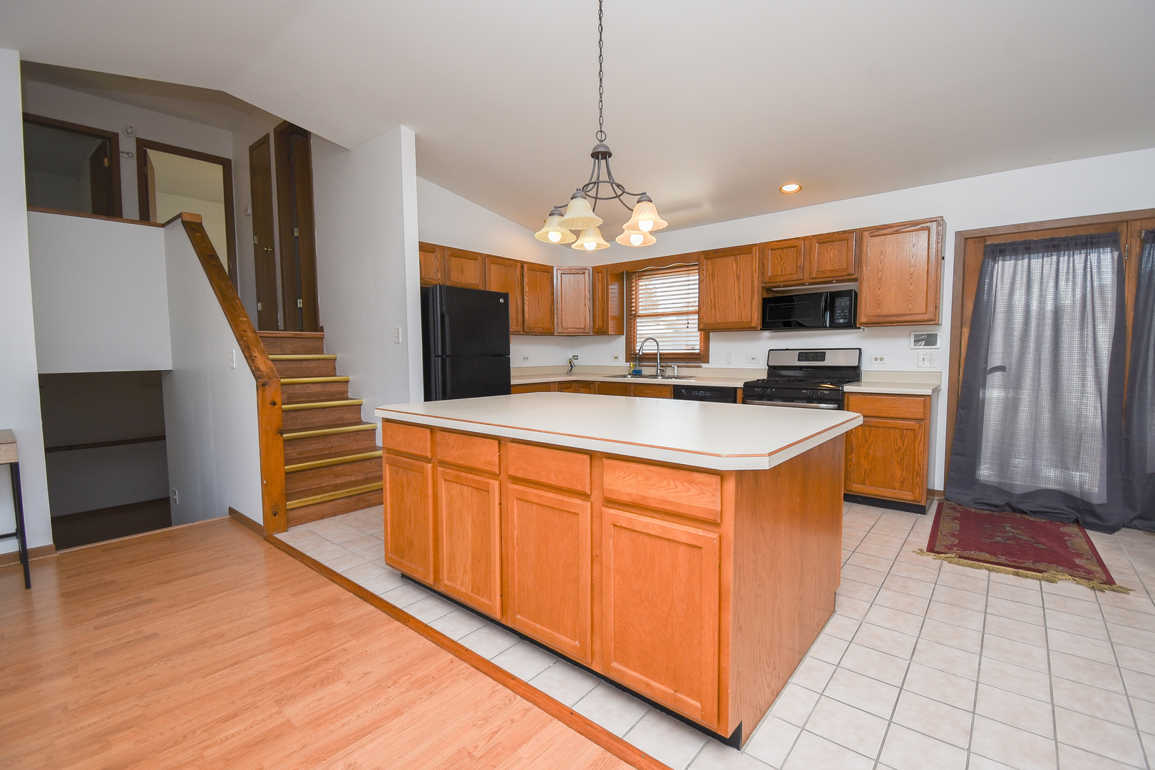 4002 Ridge Road Zion, IL 60099 - Photo 4 of 20 a kitchen with stainless steel appliances granite countertop a stove top oven a sink dishwasher and a microwave oven with cabinets