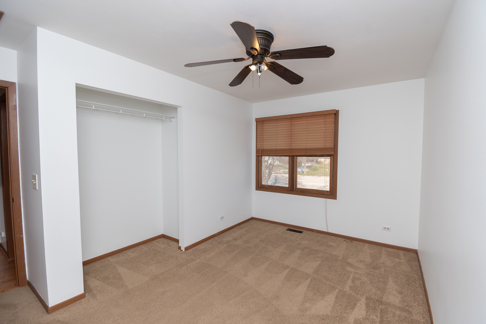 4002 Ridge Road Zion, IL 60099 - Photo 8 of 20 a view of a big room with a ceiling fan and a window