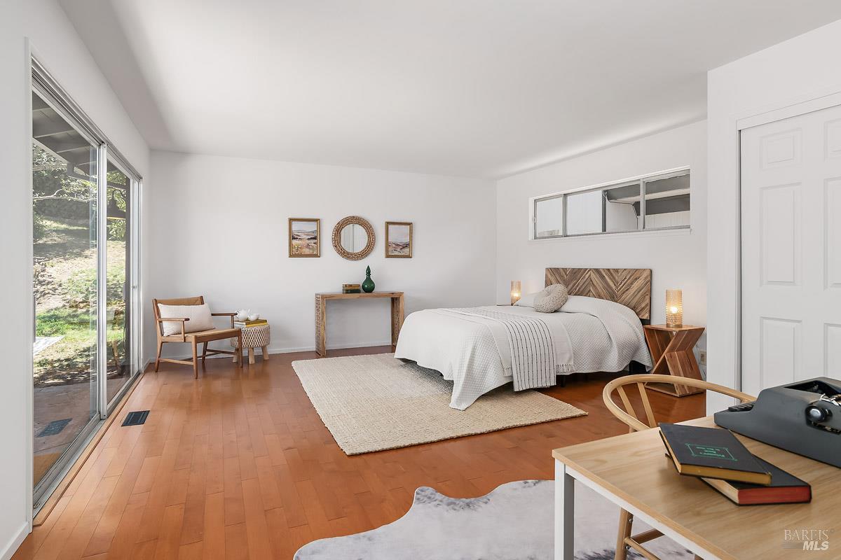 316 Riviera Drive San Rafael, CA 94901 - Photo 17 of 41 a bedroom with a bed and large windows