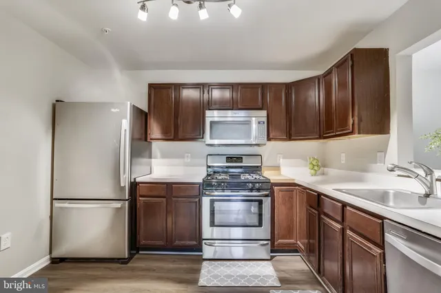 a kitchen with a sink stove and refrigerator