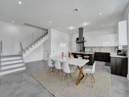 a living room with furniture and kitchen view