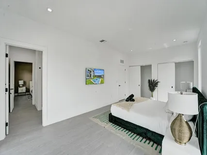 a living room with furniture and a hallway