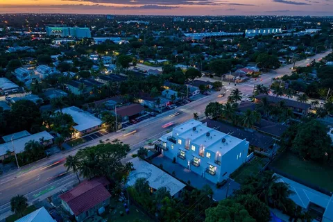 an aerial view of a house with balcony and outdoor seating