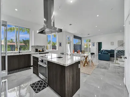 a kitchen with stainless steel appliances granite countertop a sink a stove and a refrigerator