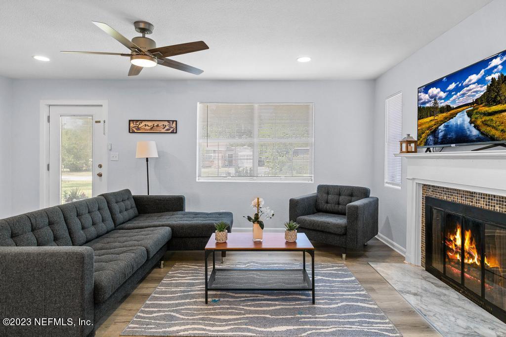 1505 Glengarry Road Jacksonville, FL 32207 - Photo 15 of 65 a living room with furniture a window and a fireplace