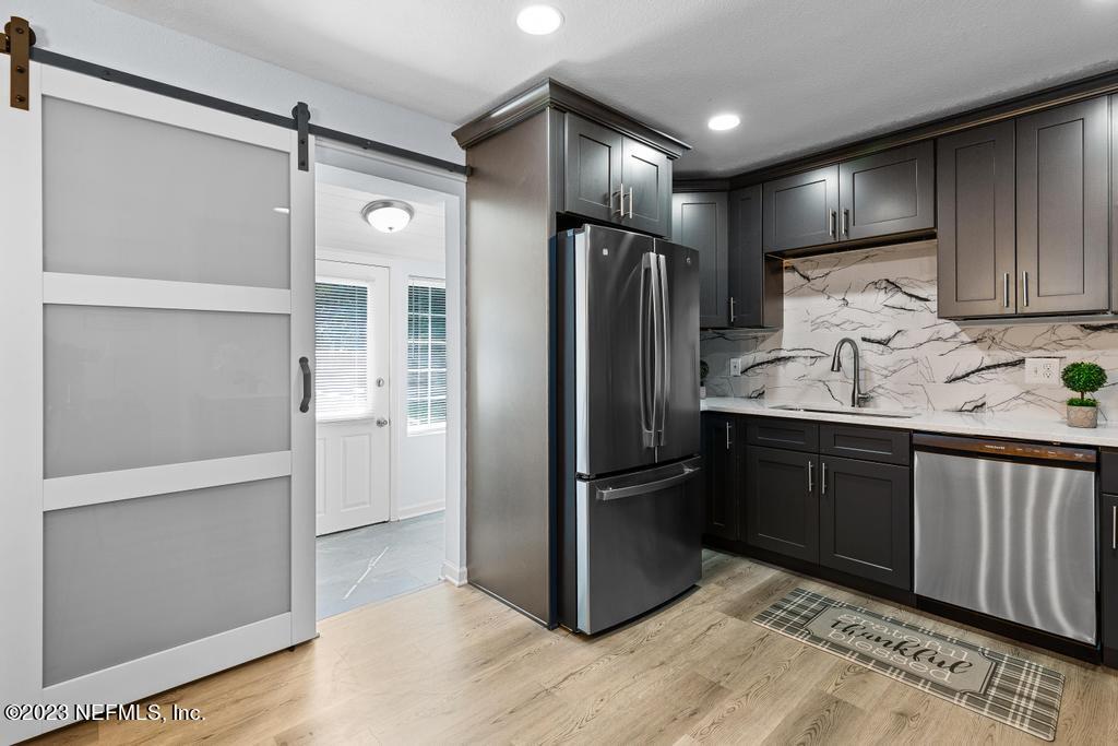 1505 Glengarry Road Jacksonville, FL 32207 - Photo 33 of 65 a kitchen with granite countertop stainless steel appliances a refrigerator and cabinets