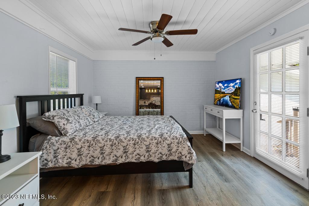 1505 Glengarry Road Jacksonville, FL 32207 - Photo 34 of 65 a bedroom with a bed a dresser and a book shelf