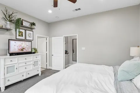 a bedroom with a bed and a flat screen tv in it