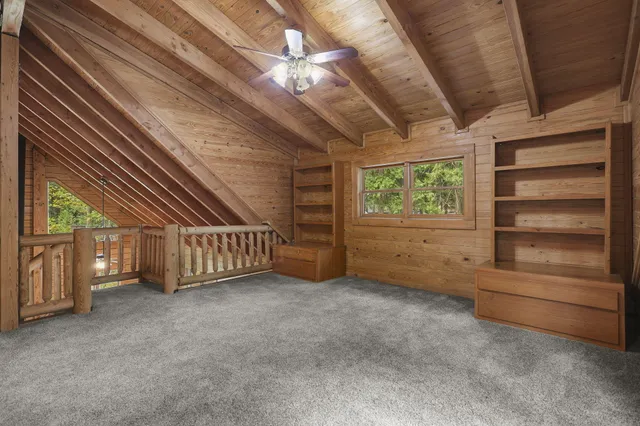 a view of a house with a yard and trees