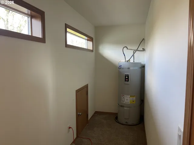 a view of storage and utility room with windows