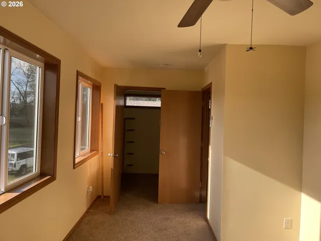 a view of a hallway with wooden shelves