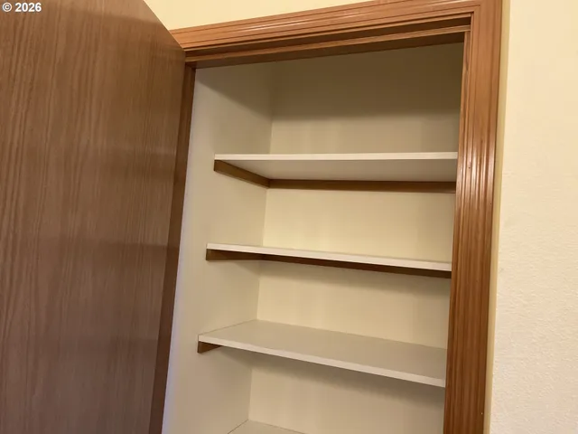 a view of a hallway with a ceiling fan