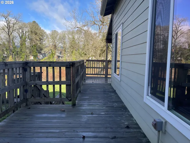 a front view of house with deck and outdoor seating