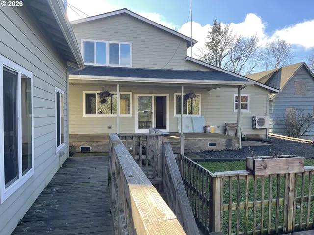 a backyard of a house with lots of green space and lake view