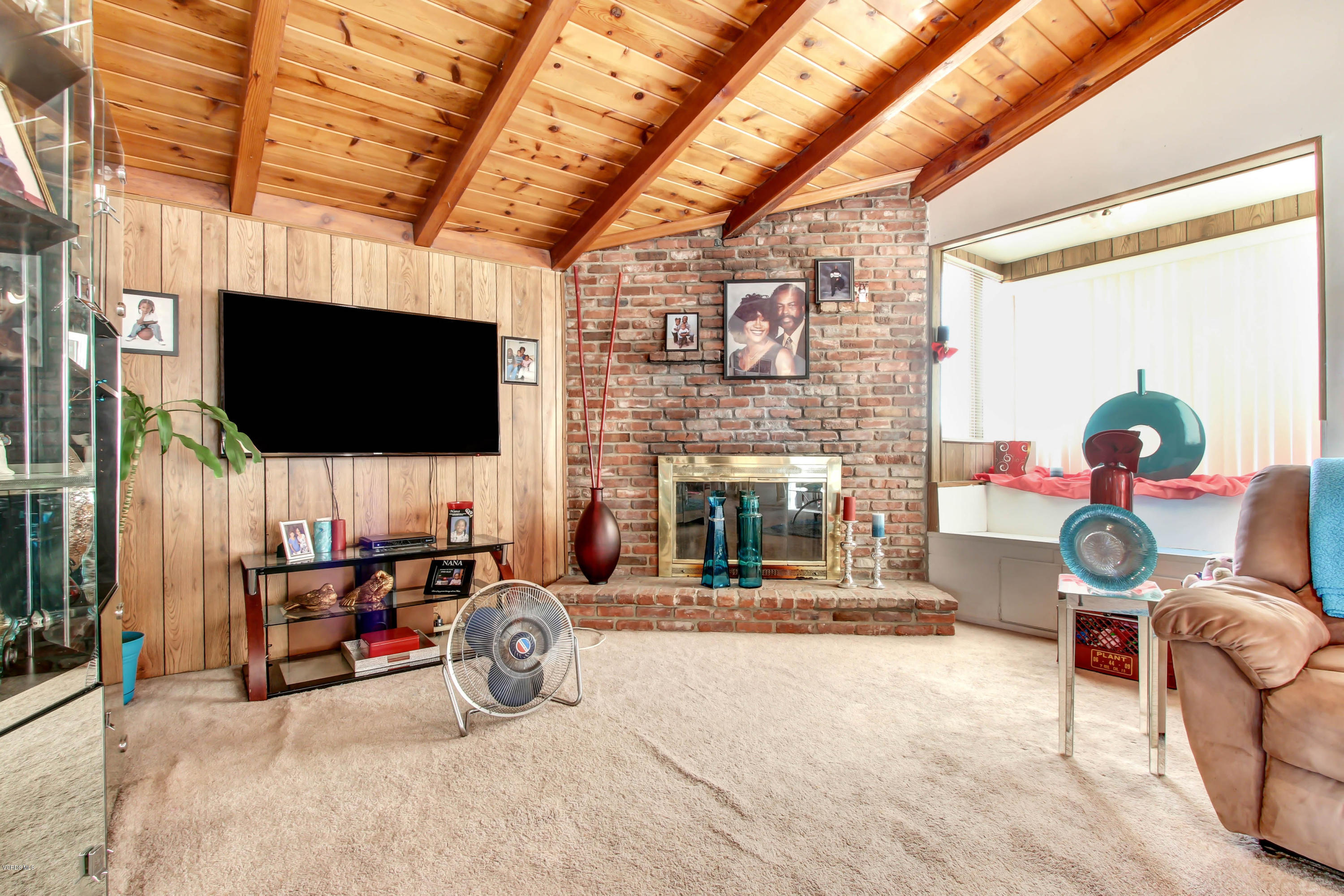 1263 Erringer Road Simi Valley, CA 93065 - Photo 14 of 44 a living room with furniture a flat screen tv and a fireplace