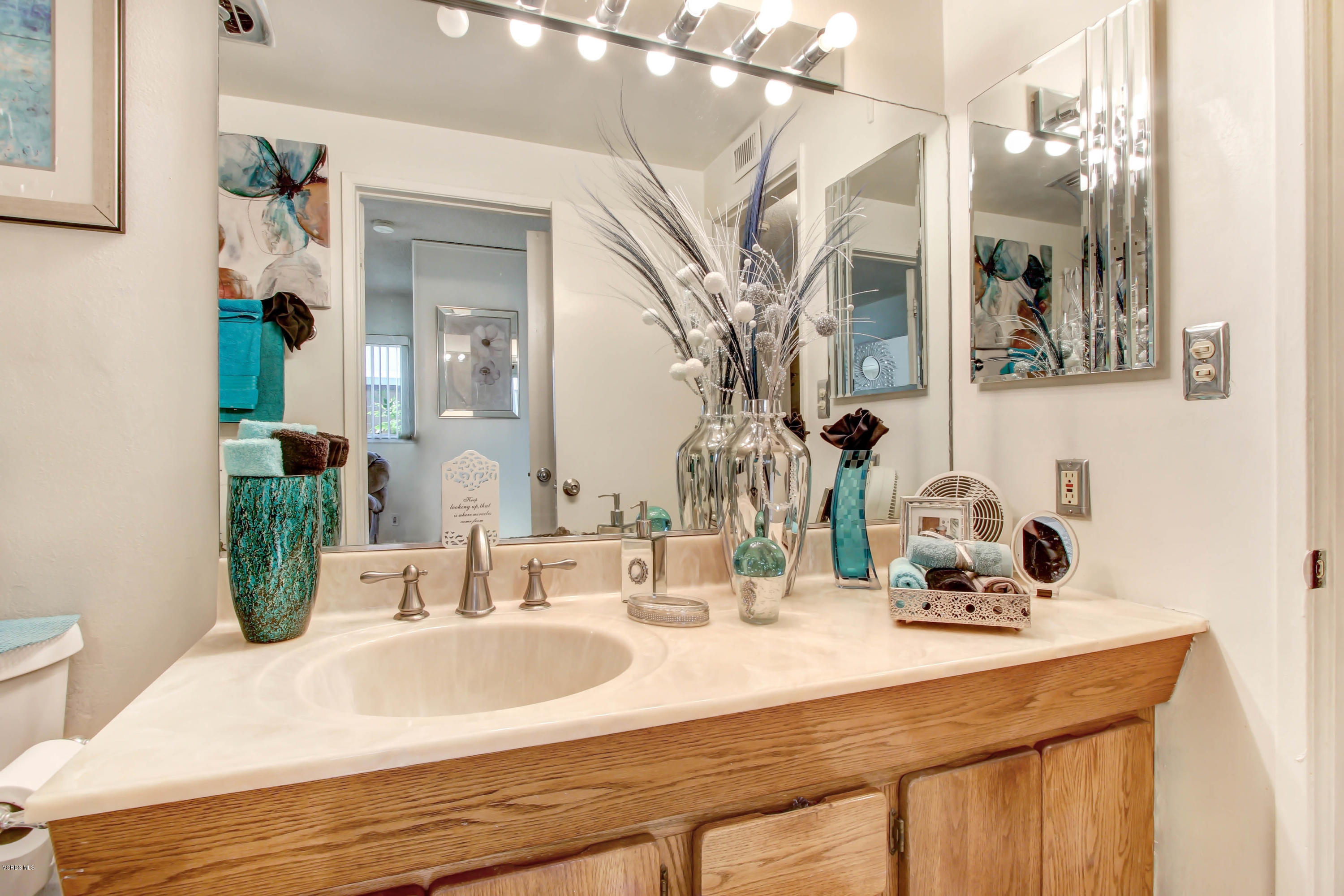 1263 Erringer Road Simi Valley, CA 93065 - Photo 22 of 44 a bathroom with a sink and a mirror