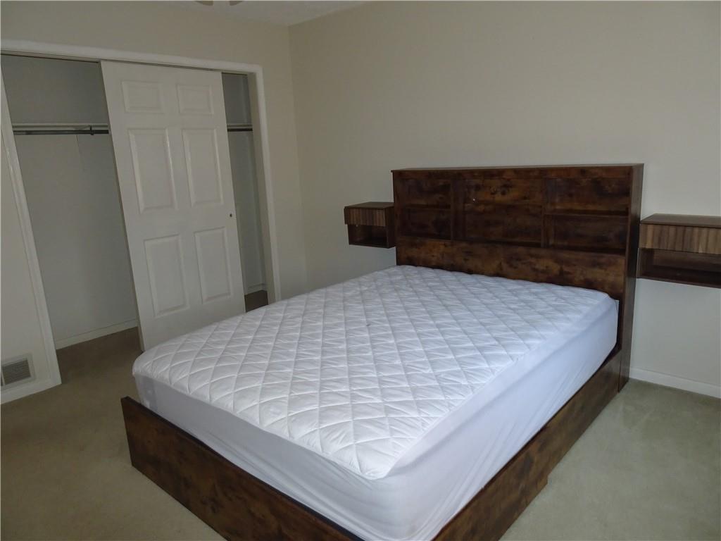 109 Canterbury Commons Indiana, PA 15701 - Photo 10 of 22 a bed sitting in a bedroom next to a cabinet