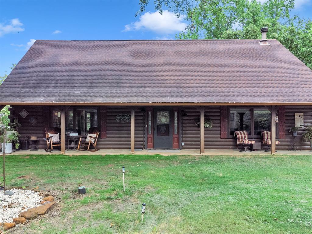 a front view of a house with garden and porch
