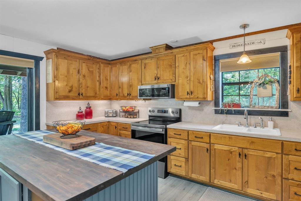 860 County Road 1627 Rusk, TX 75785 - Photo 9 of 37 a kitchen with stainless steel appliances granite countertop a sink stove and refrigerator