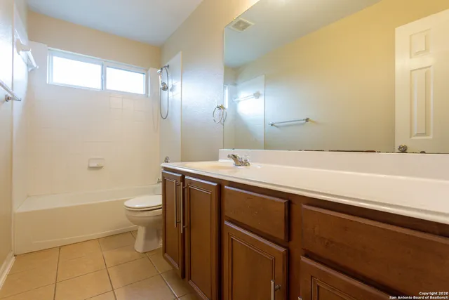 a bathroom with a sink a toilet and bathtub