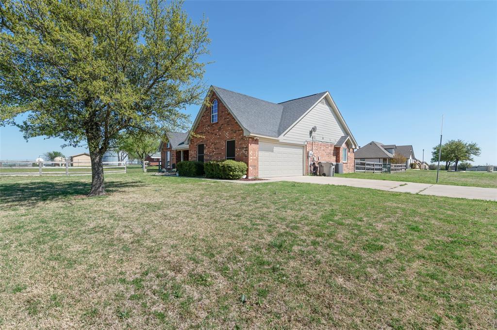 View of home's exterior with brick siding, concrete driveway, and an attached garage
