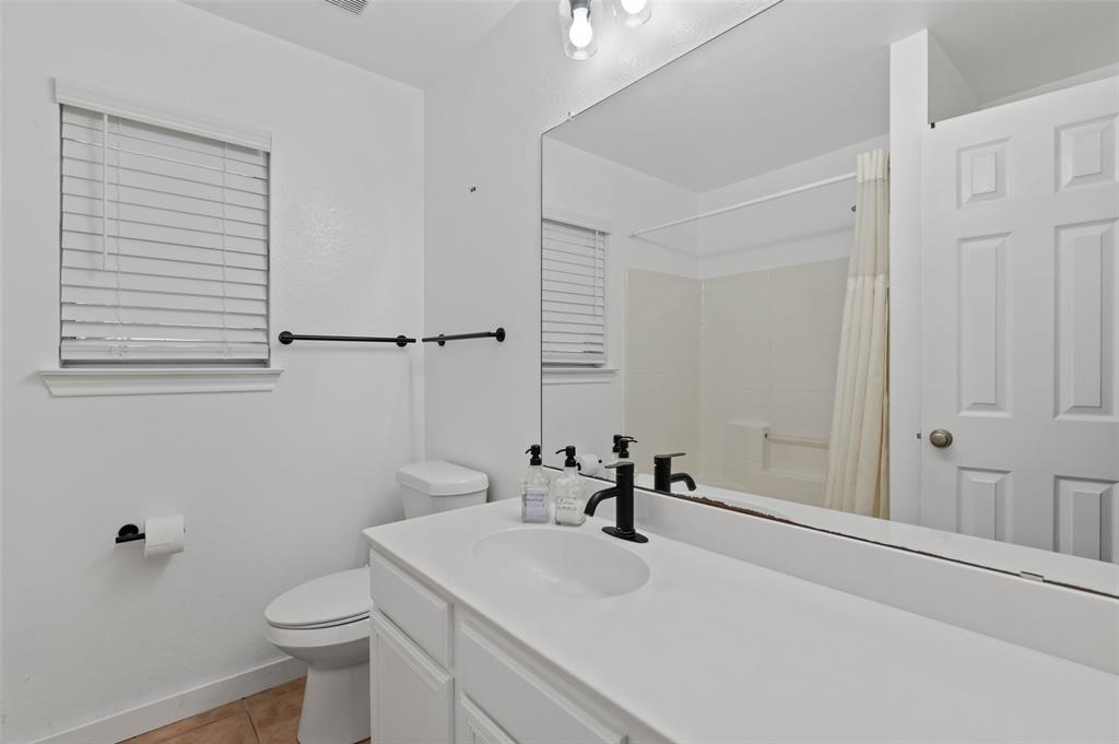 107 High View Court Decatur, TX 76234 - Photo 6 of 9 Full bathroom with vanity, curtained shower, and light tile patterned floors