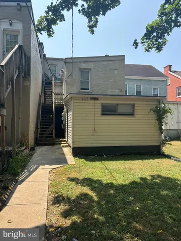 an empty room with a piano and wooden floor