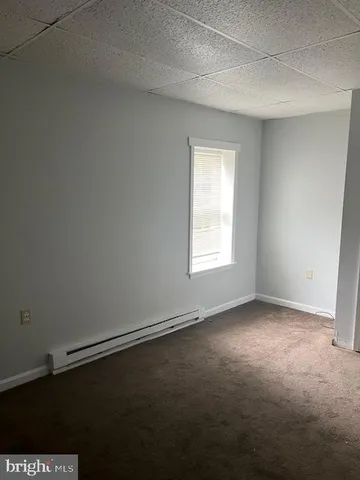 a view of wooden floor and windows in a room