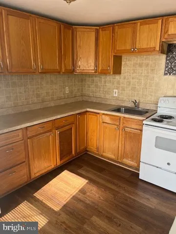an empty room with wooden floor and closet