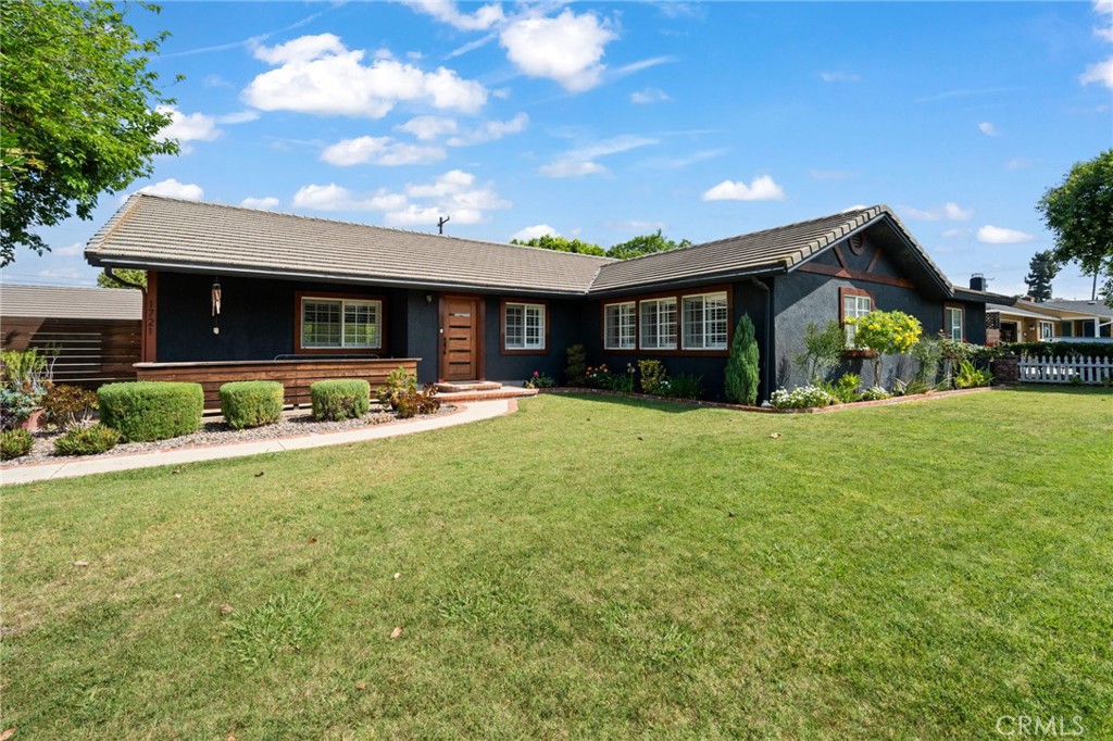 a front view of house with yard and outdoor seating