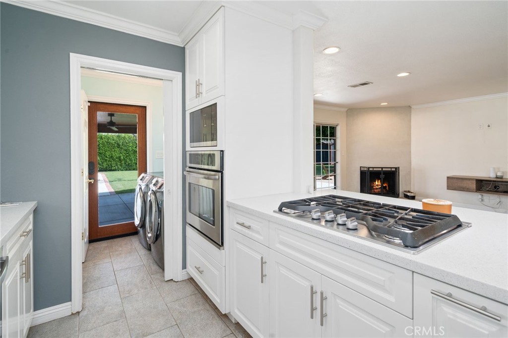 1721 East Ruddock Street Covina, CA 91724 - Photo 11 of 39 a kitchen view with stainless steel appliances granite countertop a stove and a refrigerator