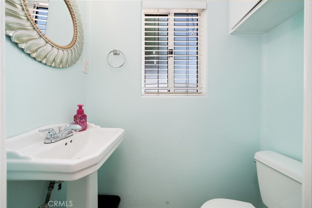 1721 East Ruddock Street Covina, CA 91724 - Photo 13 of 39 a bathroom with a sink a toilet and a mirror