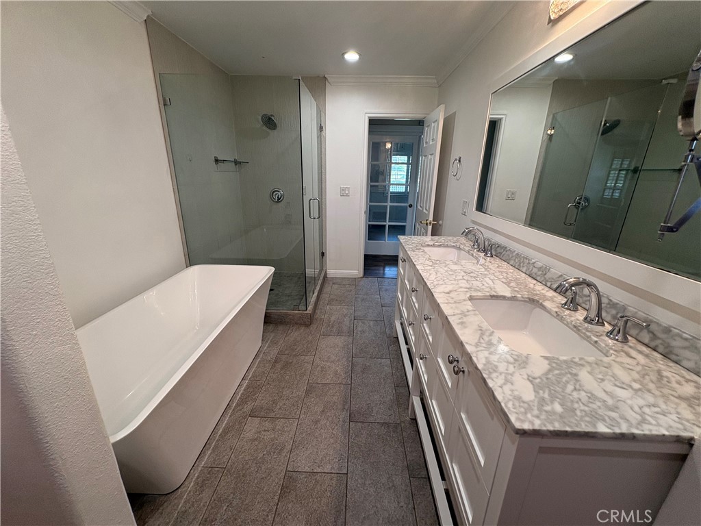 1721 East Ruddock Street Covina, CA 91724 - Photo 15 of 29 a bathroom with a granite countertop sink a mirror and a bathtub